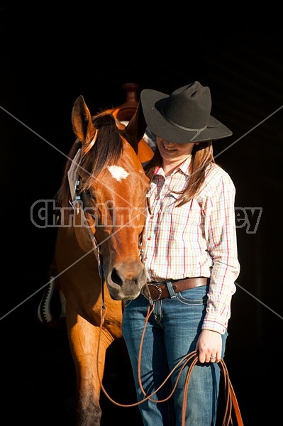 Portrait of a young woman and her American Quarter Horse gelding