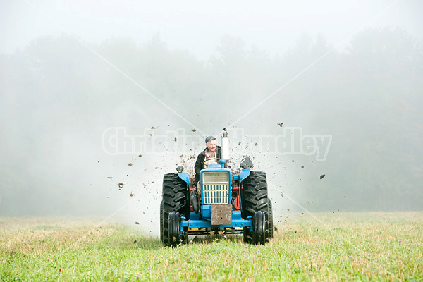 Spreading manure in the early morning fog