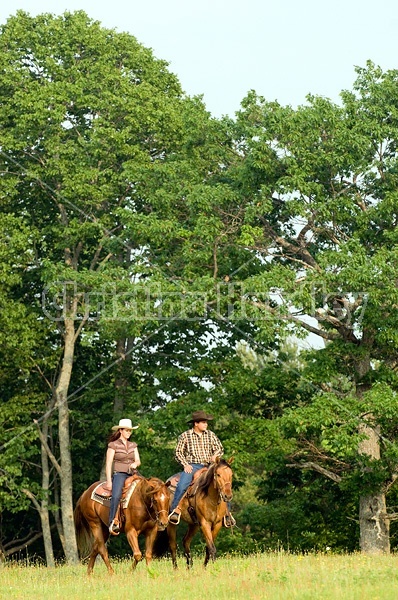 Young couple horseback riding