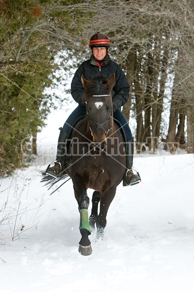 Woman horseback riding in the winter