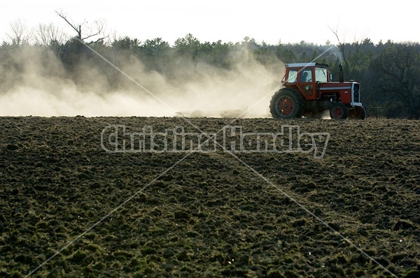 Farmer working a field in the springtime