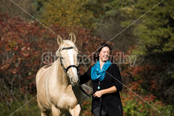 Woman with a palomino horse