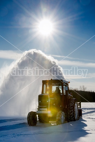 Farmer blowing snow