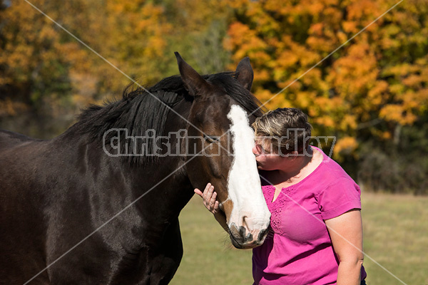 Portrait of a woman with her horse