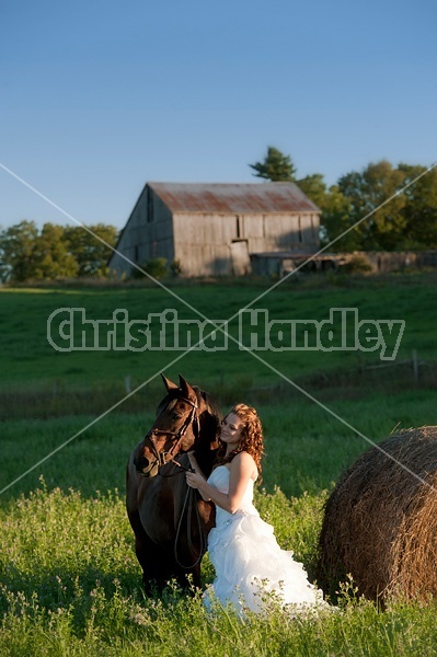 Woman in wedding dress with horse.