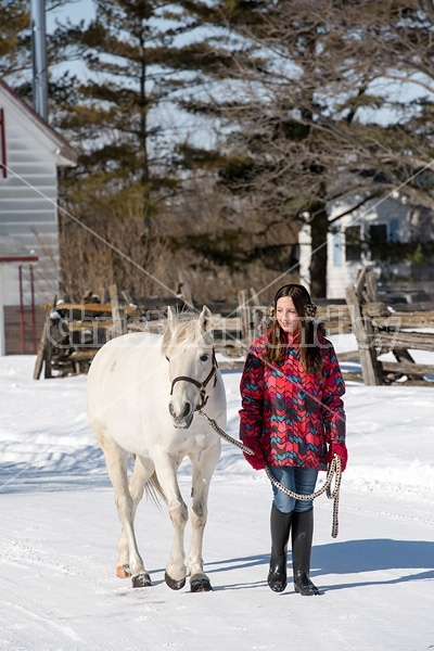 Young girl leading horse