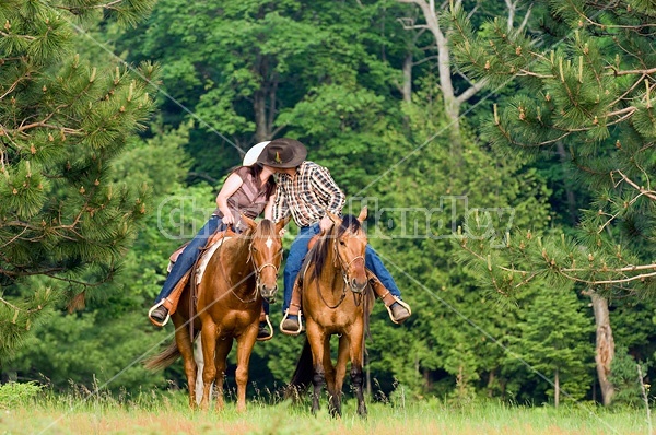 Young couple horseback riding