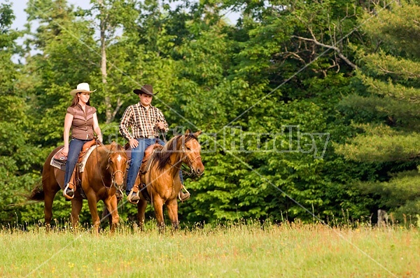 Young couple horseback riding