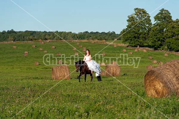 Woman riding horse wearing a wedding dress