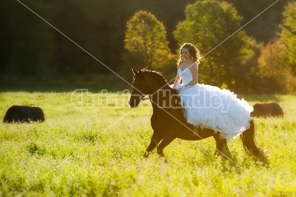 Woman riding horse wearing a wedding dress