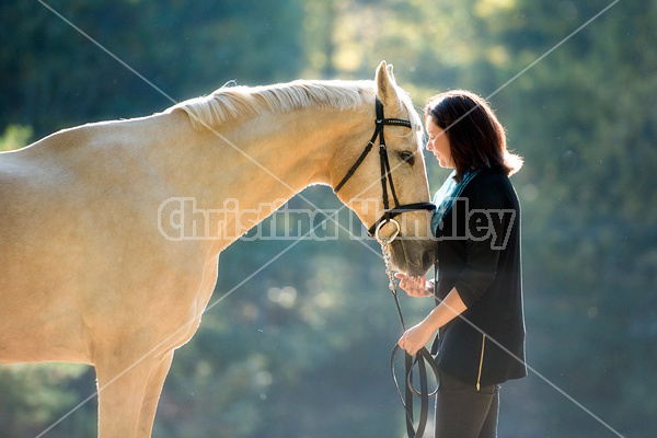 Woman with a palomino horse