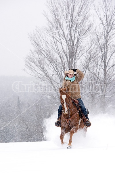 Young woman riding horse in snowstorm in Ontario Canada