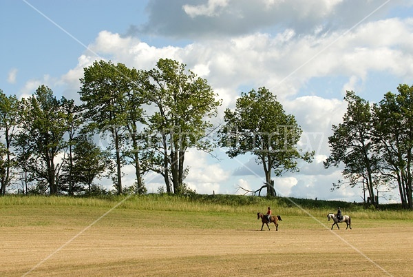 Two women horseback riding