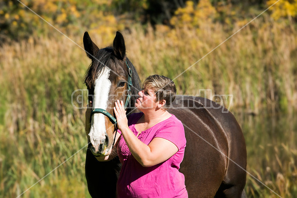 Portrait of a woman with her horse