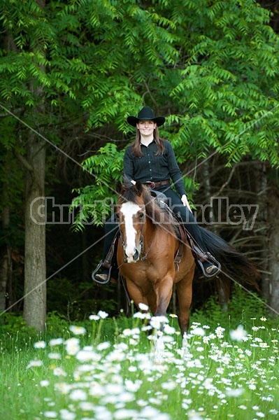 Young woman riding her American Paint horse mare