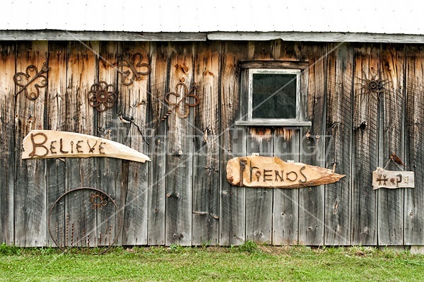 Hand crafted garden art signs made out of wood and recycled or repurposed farm tools and machinery parts