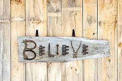 Hand crafted Believe art sign made out of wood and recycled or repurposed farm tools and machinery parts