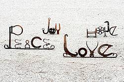 Hand crafted art signs made out of recycled and repurposed farm tools and machinery parts then welded together