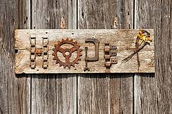 Hand crafted garden art sign made out of wood and recycled or repurposed farm tools and machinery parts