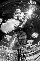Funky photo of a windmill taken with a slow shutter speed to imply motion. Photographed in infrared with a fisheye lens.