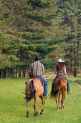 Young couple horseback riding