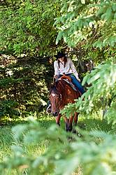 Young woman trail riding in Ontario Canada