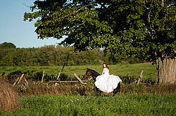Woman riding horse wearing a wedding dress