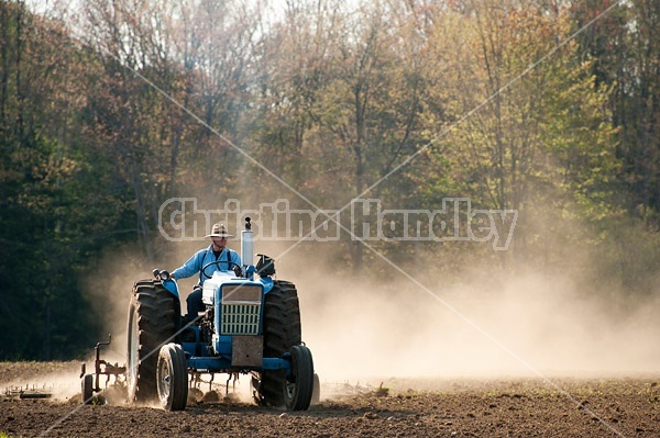 Farmer working up new field. 