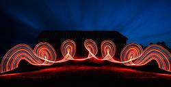 Light painting at night in front of big barn