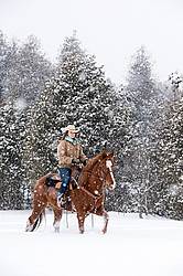 Young woman riding horse in snowstorm in Ontario Canada