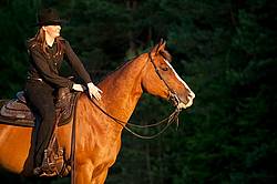 Young woman riding her American Paint horse mare