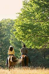 Husband and Wife Trail Riding Together