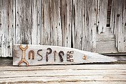 Hand crafted Inspire art sign made out of wood and recycled or repurposed farm tools and machinery parts