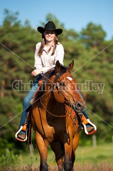 Young woman riding an American Quarter Horse gelding 