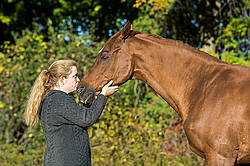 Woman with her Thoroughbred horse