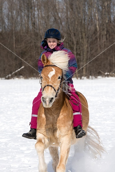 Young girl riding her pony bareback