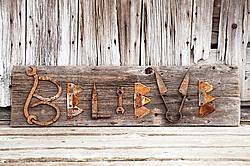 Hand crafted Believe art sign made out of wood and recycled or repurposed farm tools and machinery parts