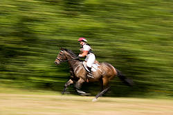 Woman riding cross country 