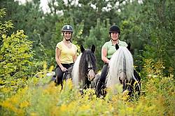 Two women riding Gypsy Vanner horses