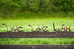 Hand crafted live love laugh garden art signs made out of recycled or repurposed farm tools and machinery parts then welded together