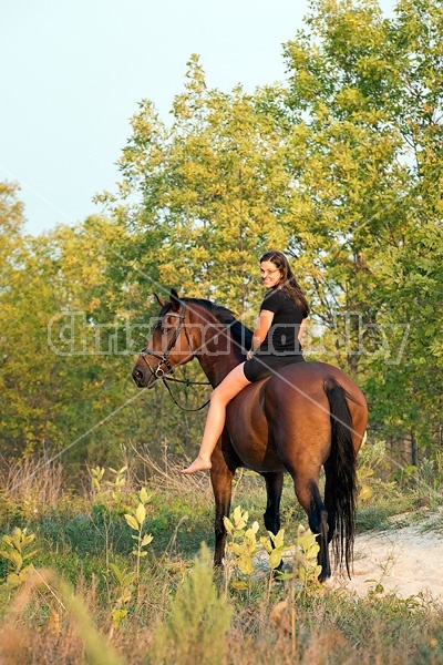 Young woman horseback riding bareback