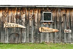 Hand crafted garden art signs made out of wood and recycled or repurposed farm tools and machinery parts